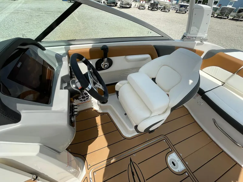 Slide: The Image of 2026 Chaparral 21 SSi boat interior with modern seating and steering wheel design. - 23