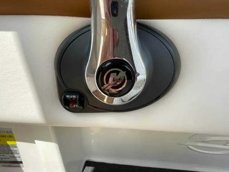 Slide: The Image of 2026 Chaparral 21 SSi boat interior with white and brown seating, modern design. - 24