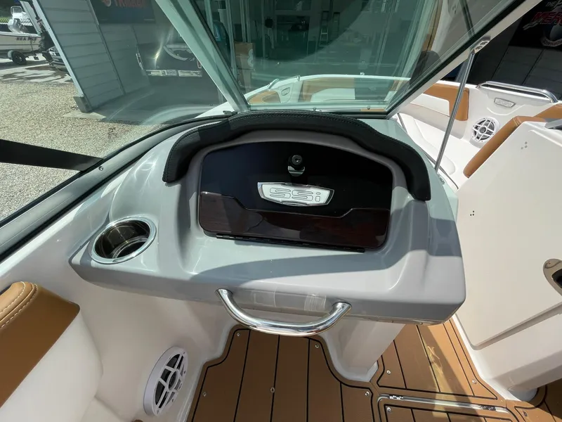 Slide: The Image of 2026 Chaparral 21 SSi boat interior with brown and white cushioned seating. - 28