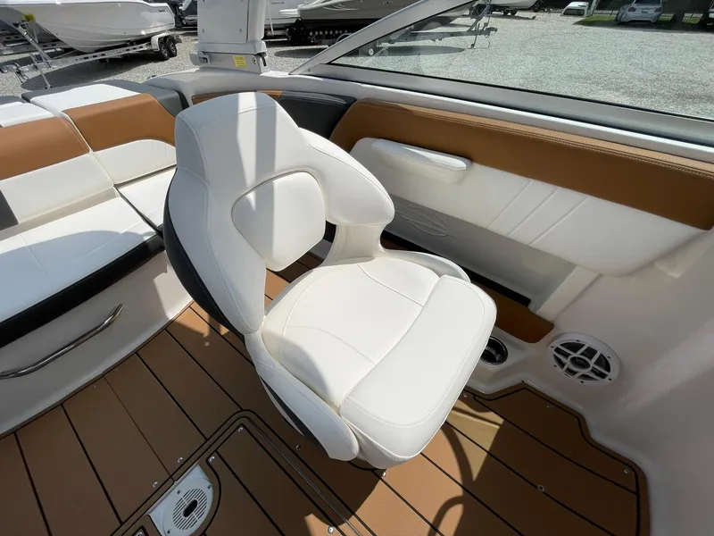 Slide: The Image of 2026 Chaparral 21 SSi boat interior with brown and white cushioned seating. - 30