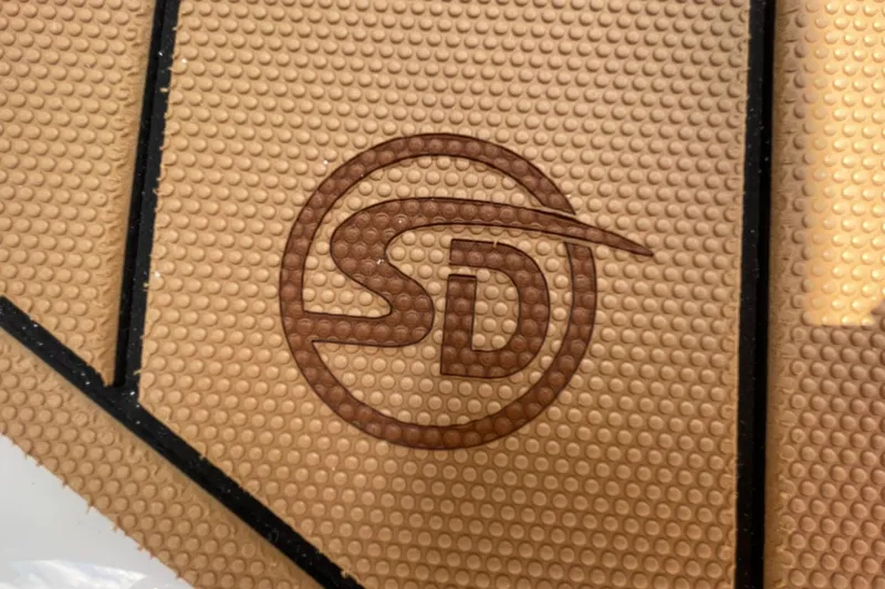 Slide: The Image of 2026 Chaparral 21 SSi boat interior with brown and white seating, storage compartment. - 32