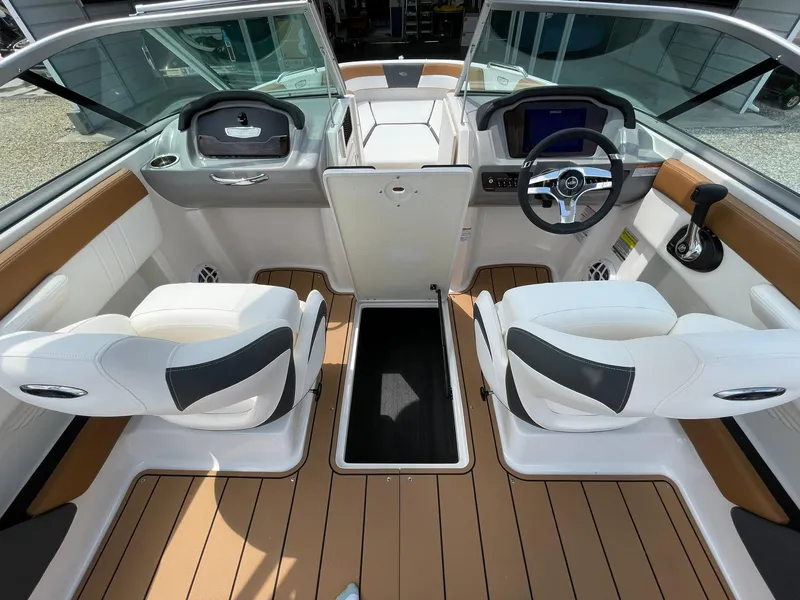 Slide: The Image of 2026 Chaparral 21 SSi boat engine compartment with open hatch, showcasing interior design. - 35