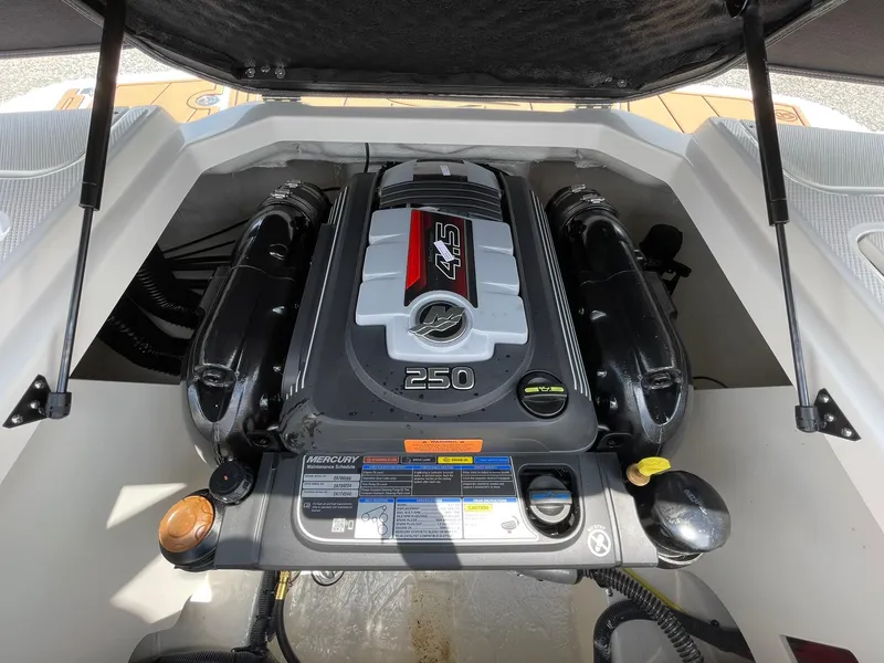 Slide: The Image of 2026 Chaparral 21 SSi boat with sleek deck and comfortable seating, docked outdoors. - 44