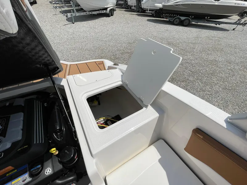 Slide: The Image of 2026 Chaparral 21 SSi boat with MerCruiser engine, displayed on gravel lot. - 46