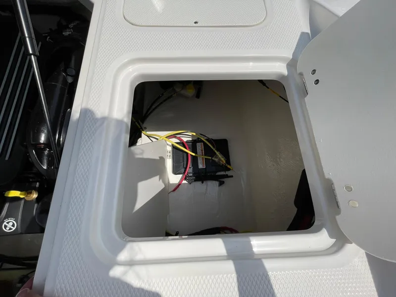 Slide: The Image of 2026 Chaparral 21 SSi boat rear view with outboard motor on gravel. - 47