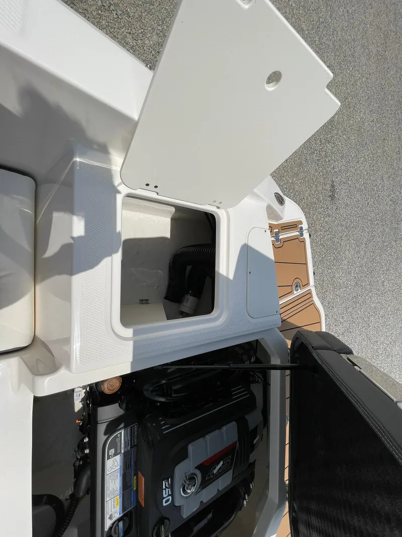 Slide: The Image of 2026 Chaparral 21 SSi boat rear view with ladder and propeller on gravel. - 48