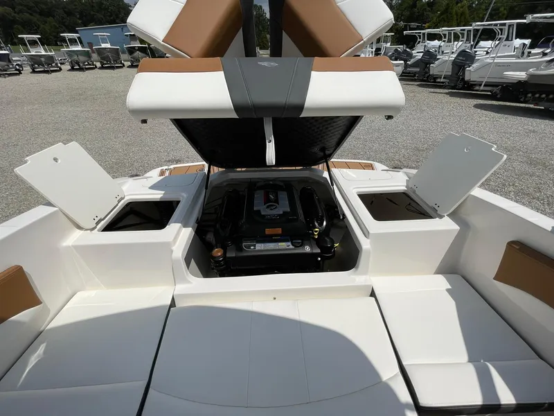 Slide: The Image of 2026 Chaparral 21 SSi boat logo on a trailer, parked on gravel. - 49