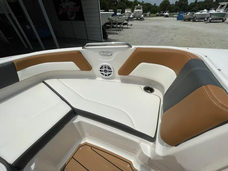 Slide: The Image of 2026 Chaparral 21 SSi boat interior with brown and white seating, speakers, and sleek design. - 6