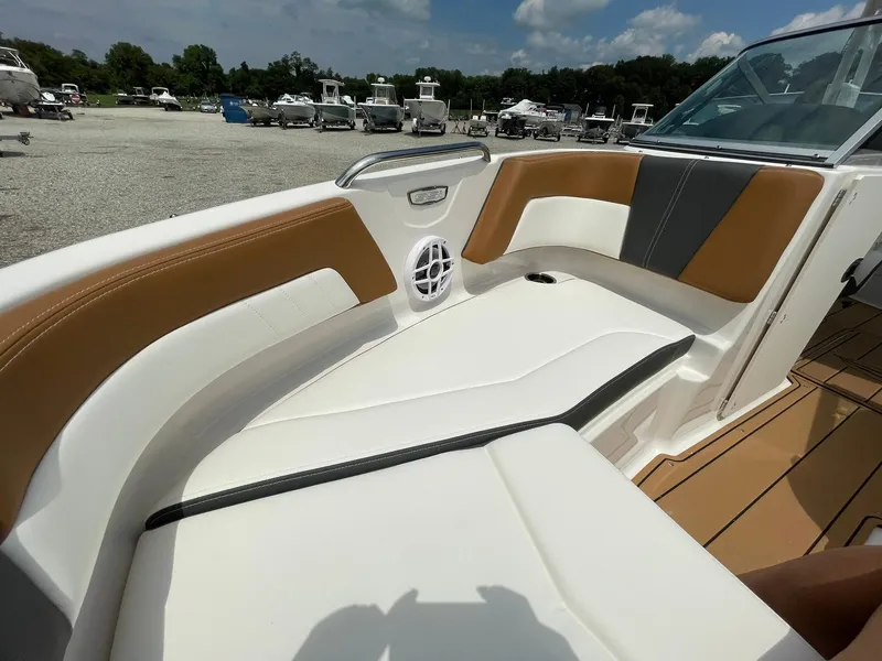 Slide: The Image of 2026 Chaparral 21 SSi boat interior with brown and white seating. - 8