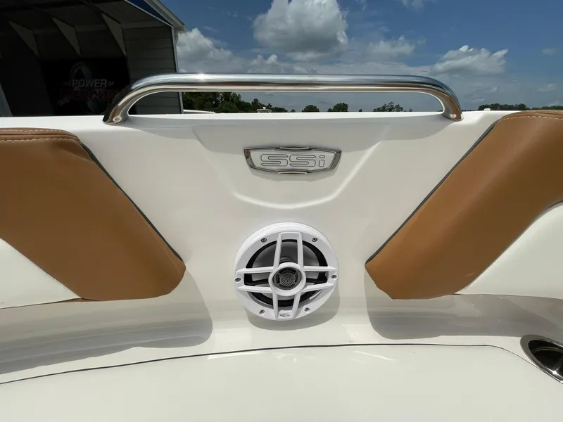 Slide: The Image of 2026 Chaparral 21 SSi boat interior with brown and white seating, featuring a speaker. - 9