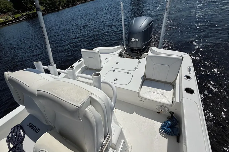 Slide: The Image of 2018 Seahunt BX25 boat interior with seating and Yamaha 300 engine on water. - 7