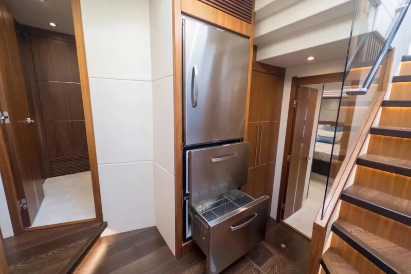 Slide: The Image of Luxurious interior of 2020 Sunseeker Predator 74 yacht with modern kitchen and staircase. - 14