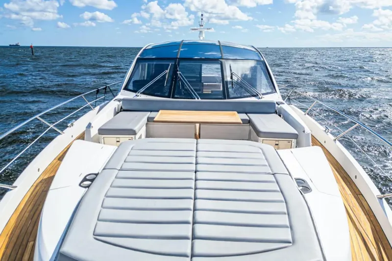 Slide: The Image of 2020 Sunseeker Predator 74 yacht on open sea, featuring luxurious deck seating. - 2