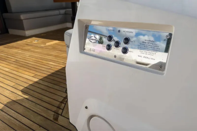Slide: The Image of Control panel on 2020 Sunseeker Predator 74 yacht with wooden deck background. - 25