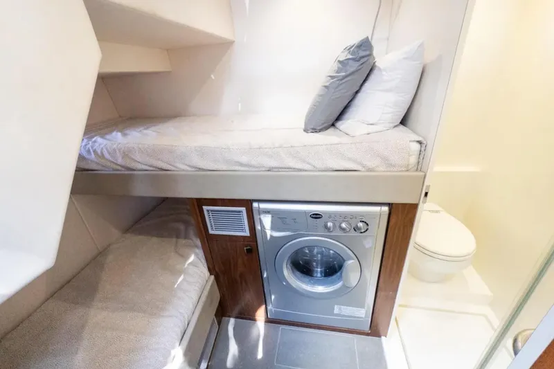 Slide: The Image of 2020 Sunseeker Predator 74 yacht cabin with bunk beds, washing machine, and bathroom. - 26