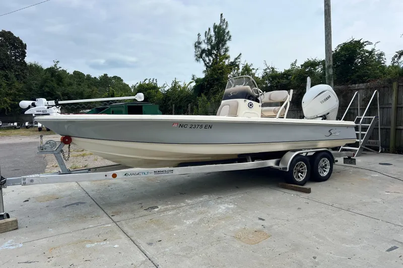 Slide: The Image of 2010 Scout 221 Winyah Bay boat on trailer, parked outdoors. - 1