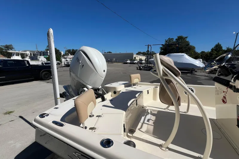 Slide: The Image of 2010 Scout 221 Winyah Bay boat with Yamaha outboard motor in a marina setting. - 11