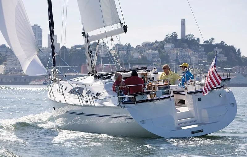 Slide: The Image of Sailing on a 2026 Catalina 445 yacht with cityscape in the background. - 2