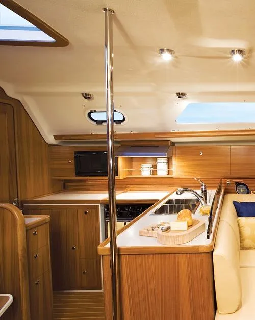 Slide: The Image of 2026 Catalina 445 yacht interior with modern kitchen and wooden cabinetry. - 5