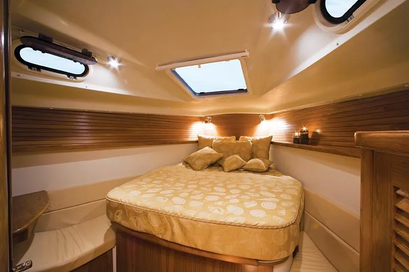 Slide: The Image of Luxurious cabin interior of 2026 Catalina 445 yacht with cozy bedding and ambient lighting. - 7