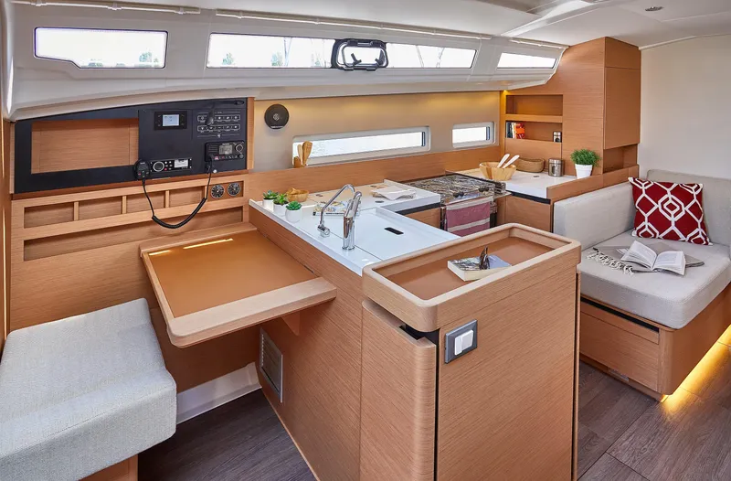 Slide: The Image of Modern interior of 2026 Jeanneau 410 yacht with sleek kitchen and cozy seating area. - 13
