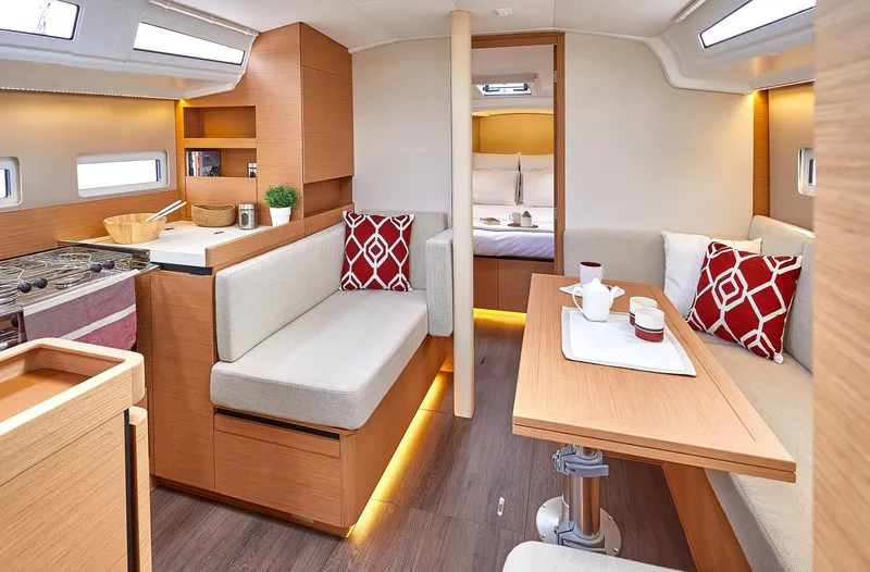 Slide: The Image of Luxurious interior of 2026 Jeanneau 410 yacht with modern seating and dining area. - 16