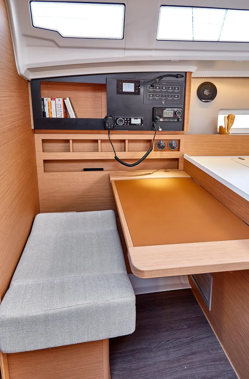 Slide: The Image of 2026 Jeanneau 410 interior with navigation station and seating area. - 21