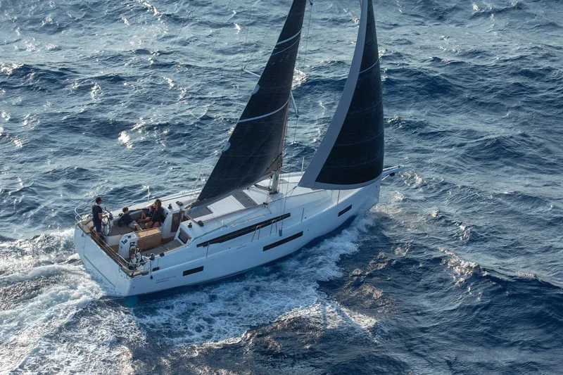 Slide: The Image of 2026 Jeanneau 410 sailboat navigating through ocean waves. - 6