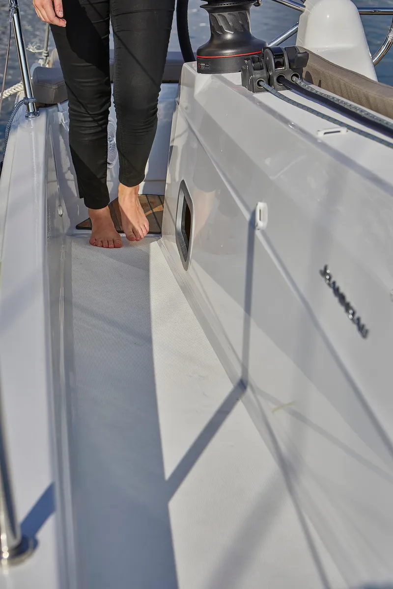 Slide: The Image of 2026 Jeanneau 410 yacht deck with person walking barefoot. - 9