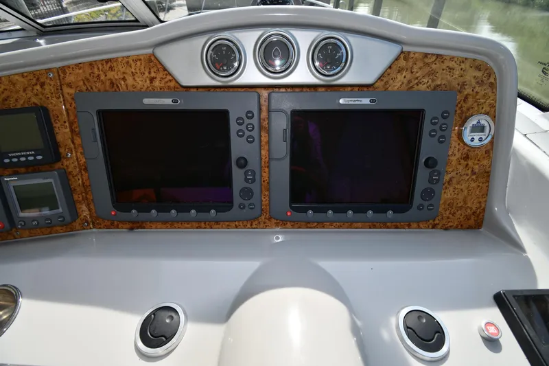 Slide: The Image of Dashboard of a 2007 Formula 45 Yacht with navigation screens and controls. - 10