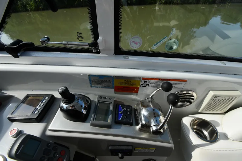 Slide: The Image of Control panel of a 2007 Formula 45 Yacht with navigation and throttle controls. - 14