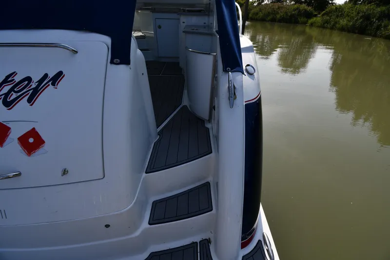 Slide: The Image of 2007 Formula 45 Yacht docked on calm water, showcasing sleek design and deck details. - 26
