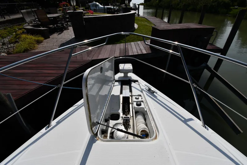 Slide: The Image of 2007 Formula 45 Yacht bow with open hatch, docked near wooden deck. - 4