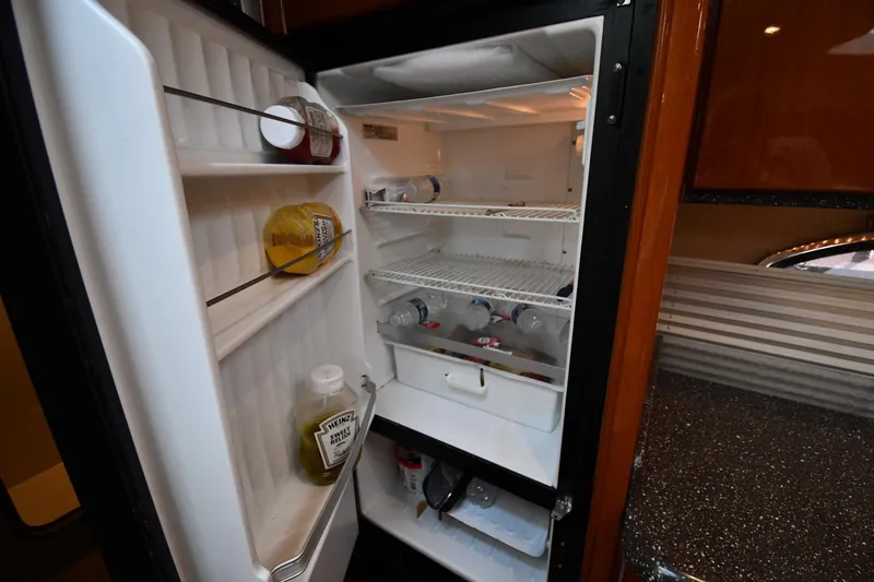 Slide: The Image of Open refrigerator inside 2007 Formula 45 Yacht, stocked with condiments and beverages. - 44