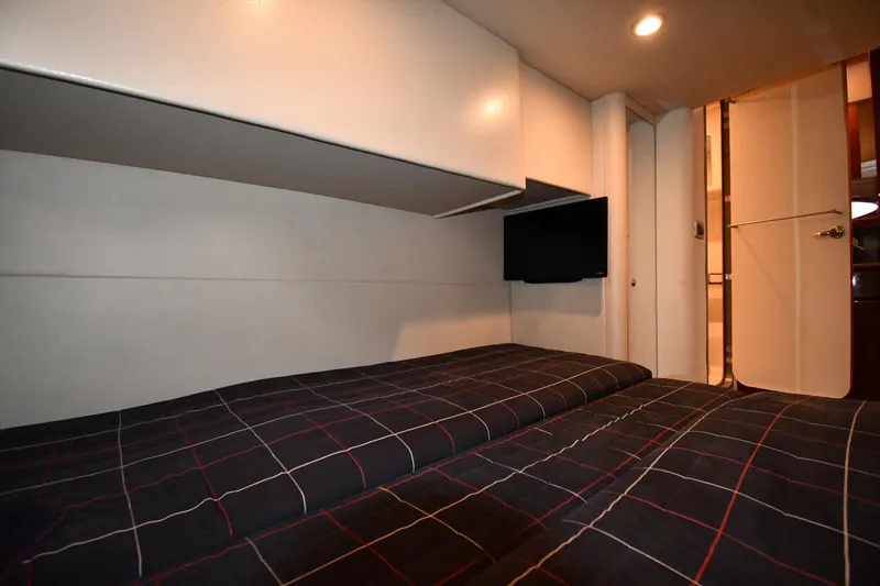 Slide: The Image of 2007 Formula 45 Yacht interior cabin with bed, TV, and modern lighting. - 48
