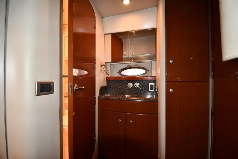 Slide: The Image of 2007 Formula 45 Yacht interior with wooden cabinetry and compact bathroom. - 49