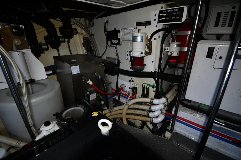 Slide: The Image of Engine room of a 2007 Formula 45 Yacht, showcasing complex machinery and piping. - 65