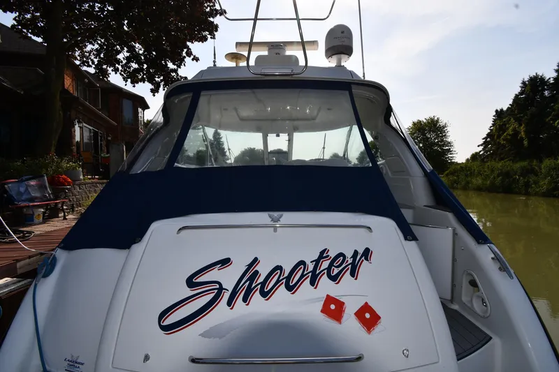 Slide: The Image of 2007 Formula 45 Yacht docked, rear view with "Shooter" name visible. - 7