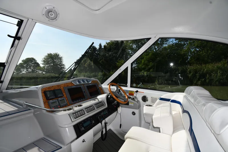 Slide: The Image of Interior view of 2007 Formula 45 Yacht cockpit with modern controls and white seating. - 9