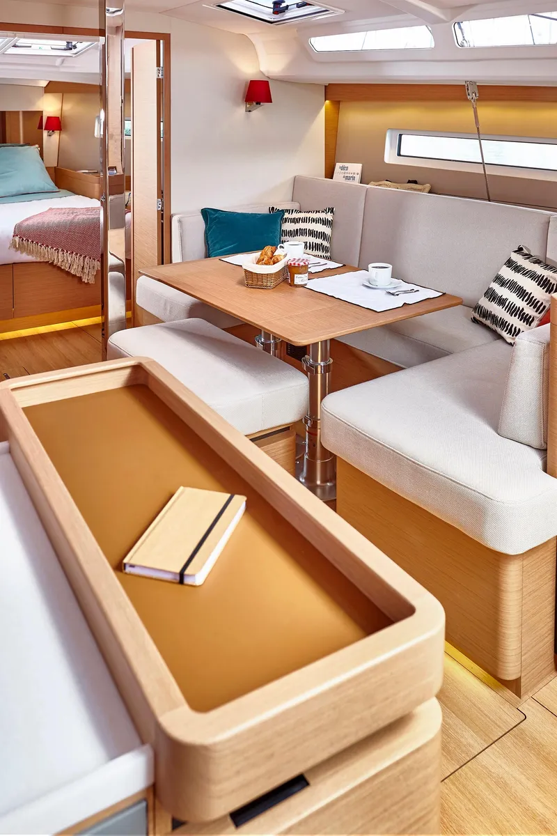 Slide: The Image of Luxurious interior of 2026 Jeanneau 440 yacht with elegant dining area and cozy seating. - 10
