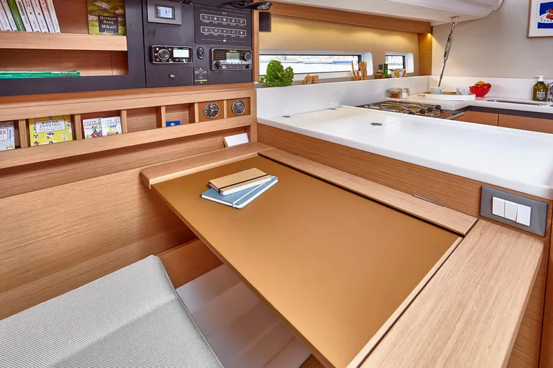 Slide: The Image of Interior of 2026 Jeanneau 440 yacht with modern navigation station and wooden finish. - 11