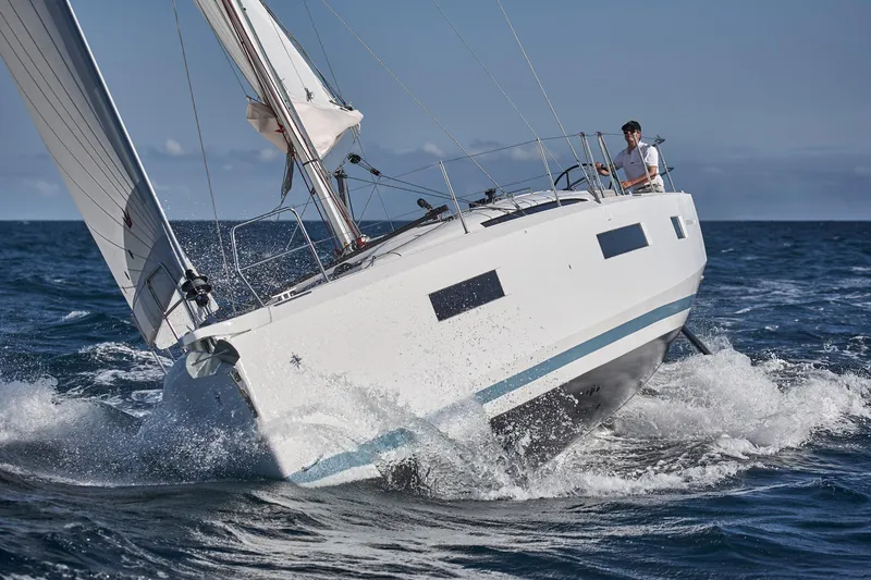 Slide: The Image of 2026 Jeanneau 440 sailboat navigating through ocean waves. - 14