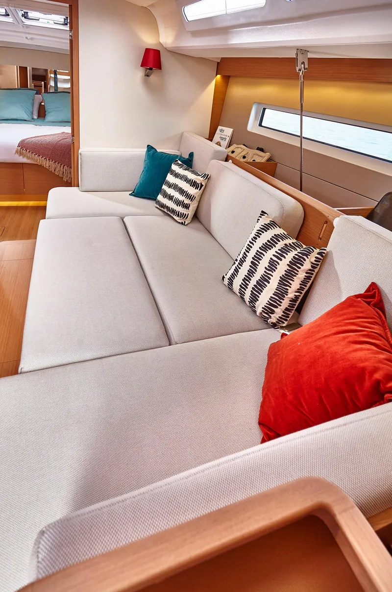 Slide: The Image of Luxurious interior of 2026 Jeanneau 440 yacht with modern sofa and vibrant cushions. - 7