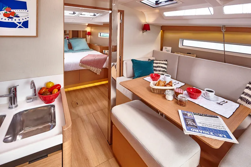Slide: The Image of Luxurious interior of 2026 Jeanneau 440 yacht with dining area and cozy bedroom. - 9