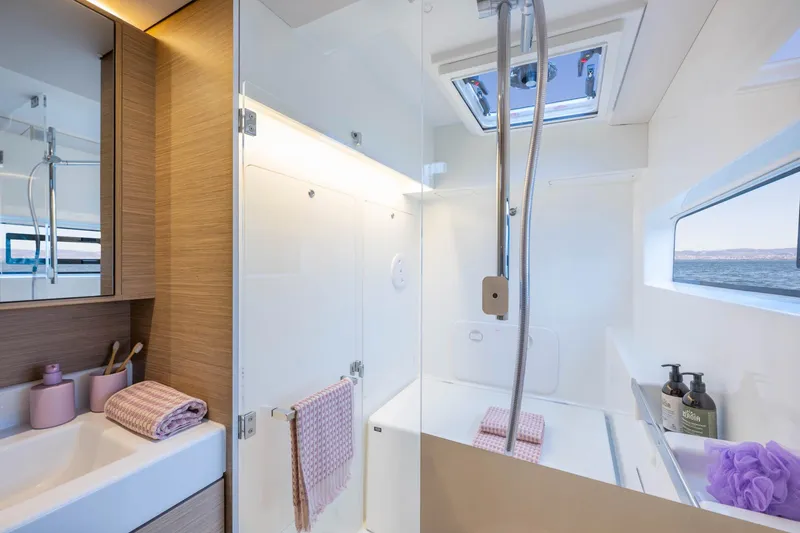Slide: The Image of Modern bathroom interior of 2026 Lagoon 38 yacht with ocean view. - 10