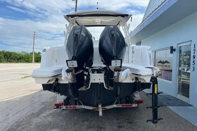 Slide: The Image of 2018 Boston Whaler 270 Vantage boat with dual outboard motors on a trailer. - 2