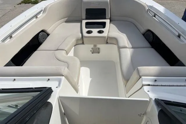 Slide: The Image of 2018 Boston Whaler 270 Vantage boat interior with cushioned seating and cup holders. - 3