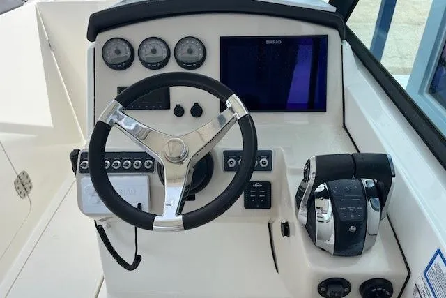 Slide: The Image of 2018 Boston Whaler 270 Vantage helm with steering wheel and control panel. - 4