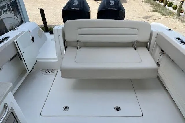 Slide: The Image of 2018 Boston Whaler 270 Vantage boat interior with seating and dual outboard motors. - 7