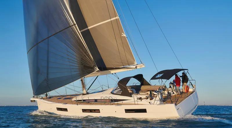 Slide: The Image of 2026 Jeanneau Yachts 60 sailing on open water under clear blue skies. - 1